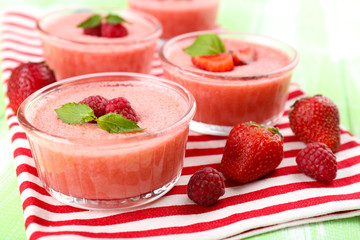 Delicious berry mousse in bowls on table close-up