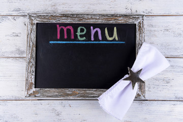 Inscription menu on chalkboard on table close-up