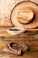 Fototapeta na wymiar American West still life with old horseshoe, hat and cowboy