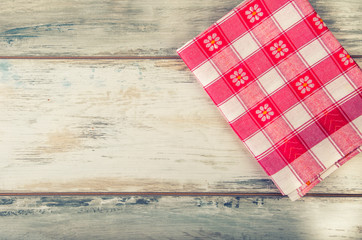 Top view of checkered napkin on old wooden table