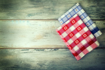 Top view of checkered napkin on old wooden table