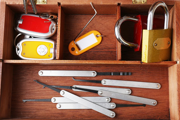 Set of keys and lock picks in wooden box close-up