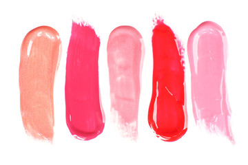 Different lip glosses isolated on white