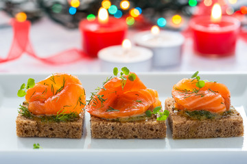 Delicious appetizer canapes of black bread with smoked salmon