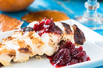 Sliced chicken breast with cranberry sauce