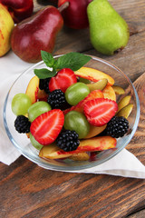 Fototapeta na wymiar fresh tasty fruit salad on wooden table