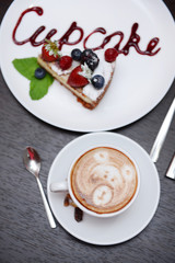 Cup of coffee with cute drawing in cafe