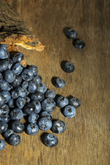 Tasty ripe blueberries, on wooden background