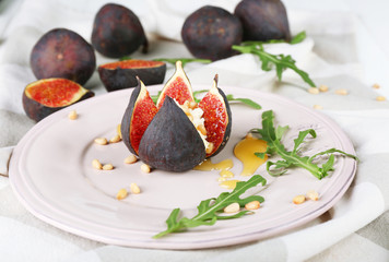 Ripe sweet fig with cottage cheese and honey, on plate