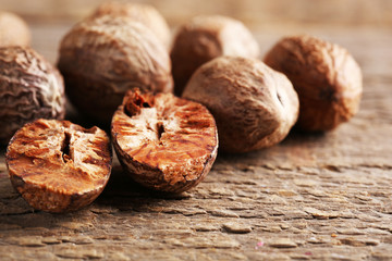 Nutmegs on wooden background