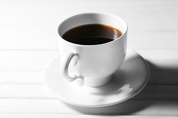 Cup of coffee on wooden table