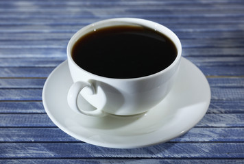 Cup of coffee on wooden table