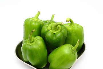 Green capsicum or pepper on white background, close up
