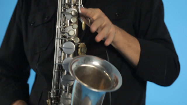 Close up of saxophone and  musician playing it