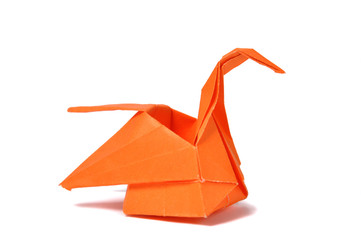 Orange origami swan over white