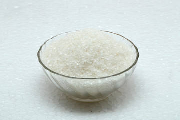 Sugar in glass bowl isolated on white