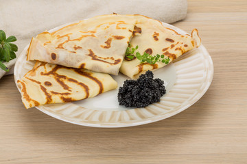 Pancakes with black caviar