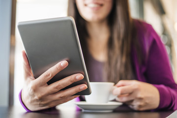 Woman reading an article on her tablet