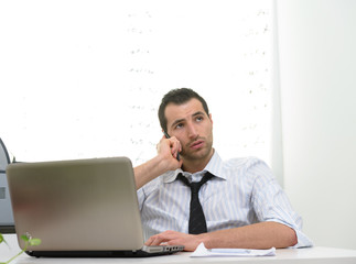Businessman with laptop talking on the phone