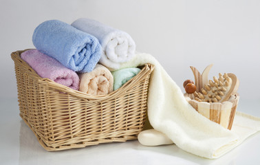 Set of rolled towels and bath accessories, isolated on white