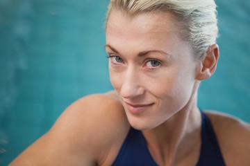 Fototapeta na wymiar Close-up portrait of a female swimmer by pool