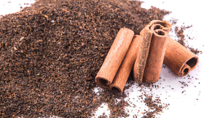 Cinnamon stick on dried and processed tea leaves