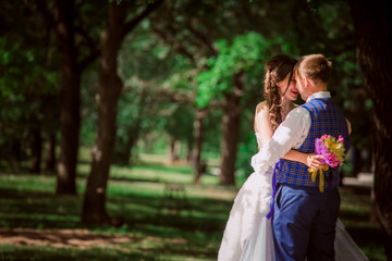 the newly married couple standing at park