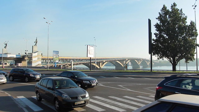 car traffic through pedestrian crossing near bridge on Dnieper