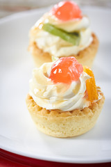 Small fruit tart with vanilla frosting