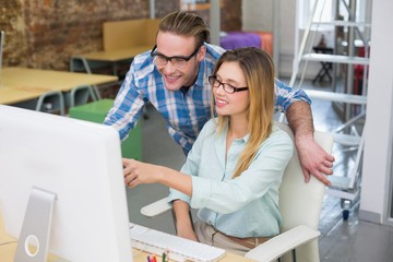 Photo editors using computer in office