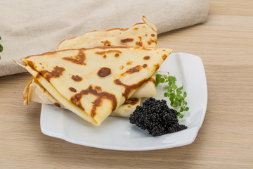 Pancakes with black caviar