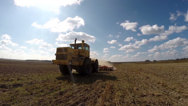 Farmer in tractor preparing land