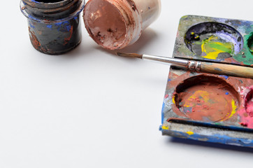 Water colour and gouache of paint and brush on white background