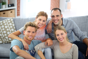 Roommates sitting together in couch