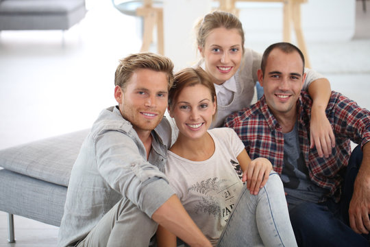 Group of young people sitting in shared apartment