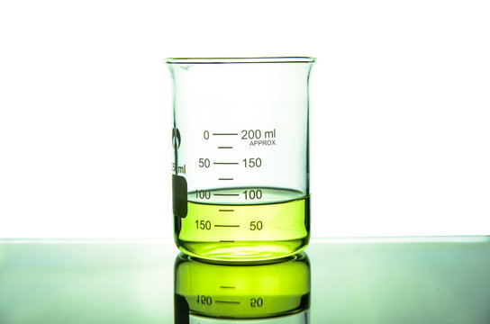 beaker tube with green liquid on table