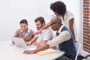 Concentrated business team using laptop in meeting