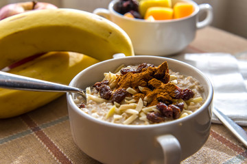 Fresh fruit and oatmeal with healthy toppings for breakfast