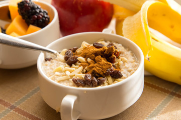 Fresh fruit and oatmeal with healthy toppings for breakfast