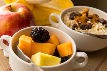 Fresh fruit and oatmeal with healthy toppings for breakfast