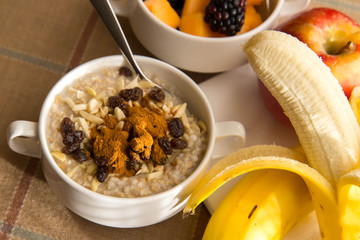 Fresh fruit and oatmeal with healthy toppings for breakfast