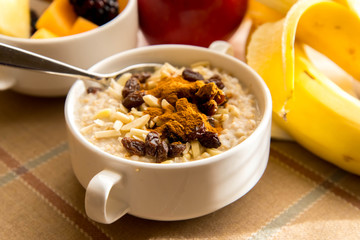 Fresh fruit and oatmeal with healthy toppings for breakfast