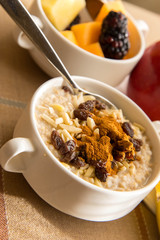 Fresh fruit and oatmeal with healthy toppings for breakfast