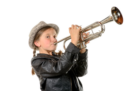 a pretty little girl with a black jacket plays the trumpet