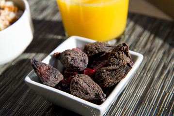 dried figs, oatmeal and orange juice breakfast setting