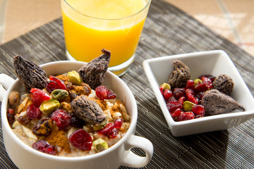 dried figs, oatmeal and orange juice breakfast setting