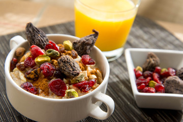 dried figs, oatmeal and orange juice breakfast setting