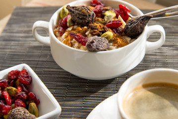coffee and oatmeal with fruit and nuts breakfast setting