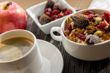 coffee and oatmeal with fruit and nuts breakfast setting