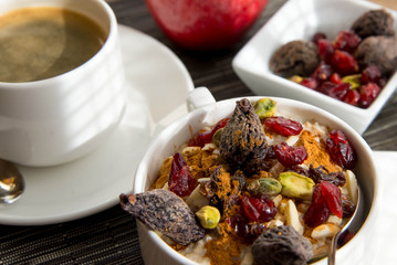 coffee and oatmeal with fruit and nuts breakfast setting